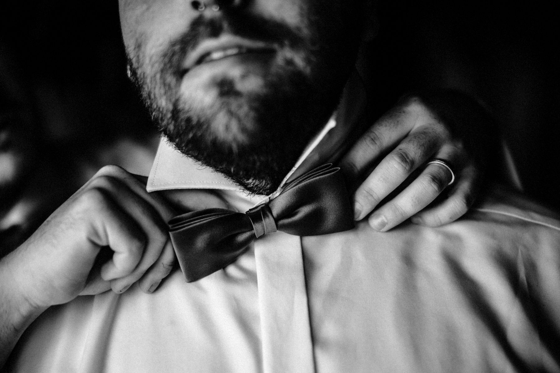Bräutigam bindet vor der Hochzeit seine Fliege — CheersMates begleitet Hochzeiten in Mittelhessen